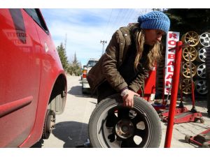 Kocasının yanında lastik tamir ediyor