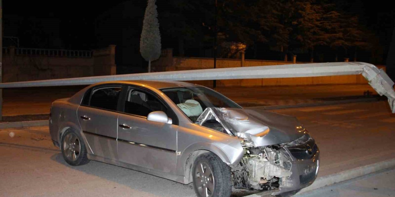 Çarptığı direk otomobilin üzerine devrildi