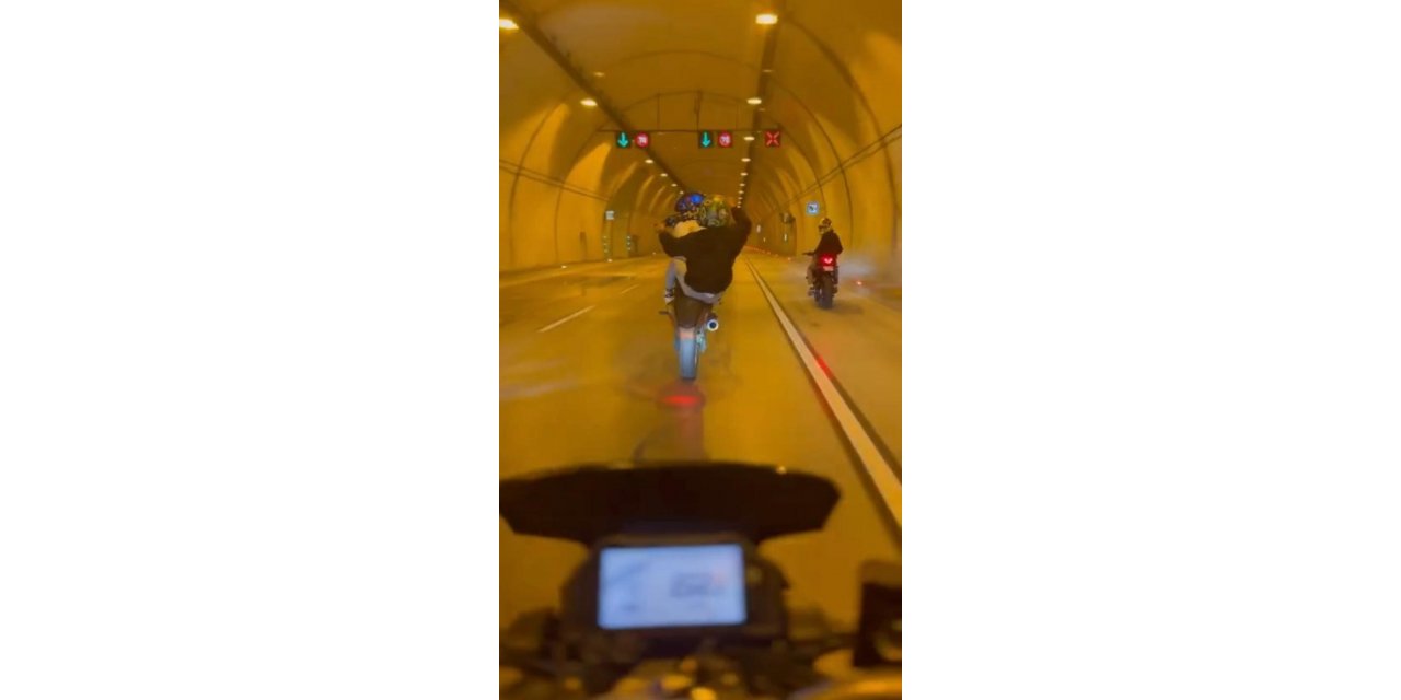 Tünelde motosikletle tek teker giden maganda kamerada