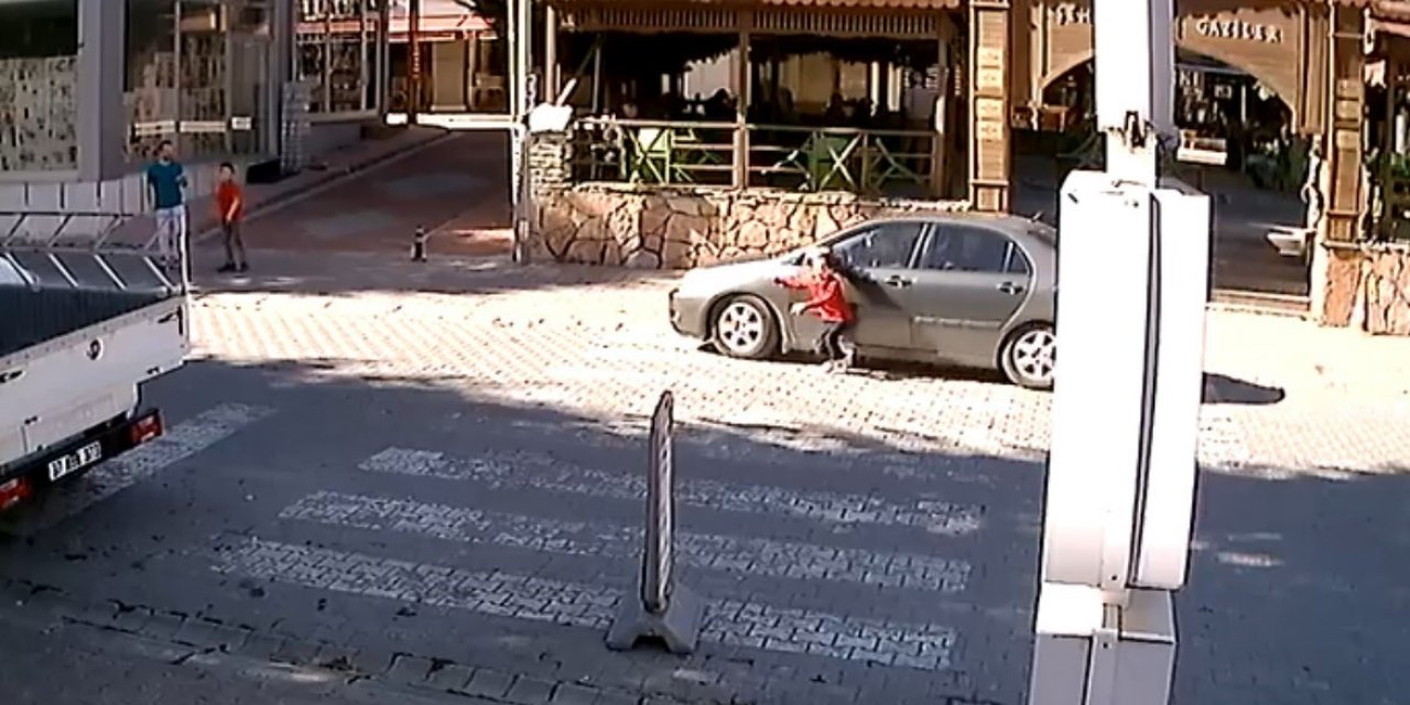 Yaya geçidinden karşıya geçmek isteyen çocuk, otomobilin altında kalmaktan son anda kurtuldu