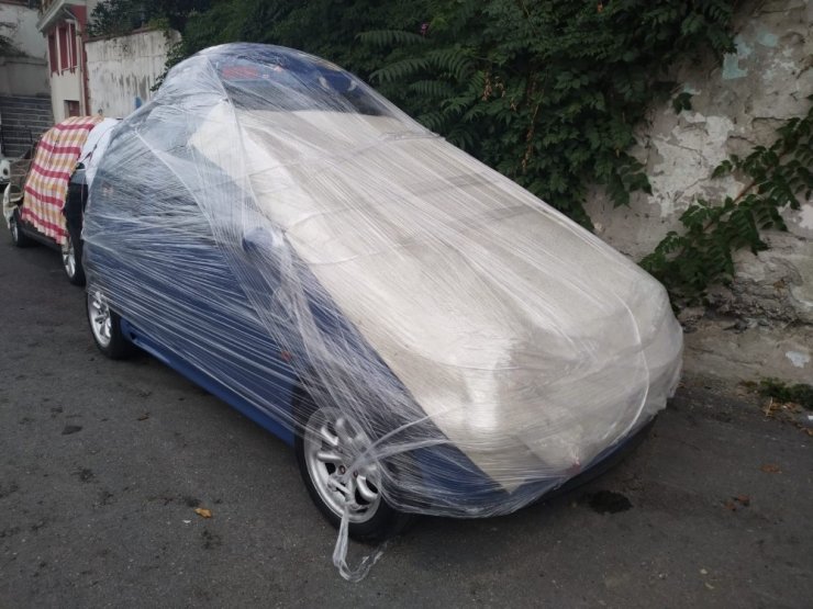 Aracını doludan korumak isteyen sürücüden sıra dışı yöntem: otomobili streç ile sardı