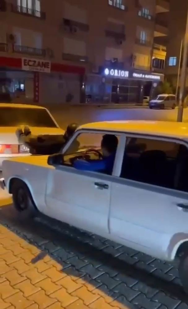 İki otomobilin arasına uzanıp, arızalanan aracı ayaklarıyla itti