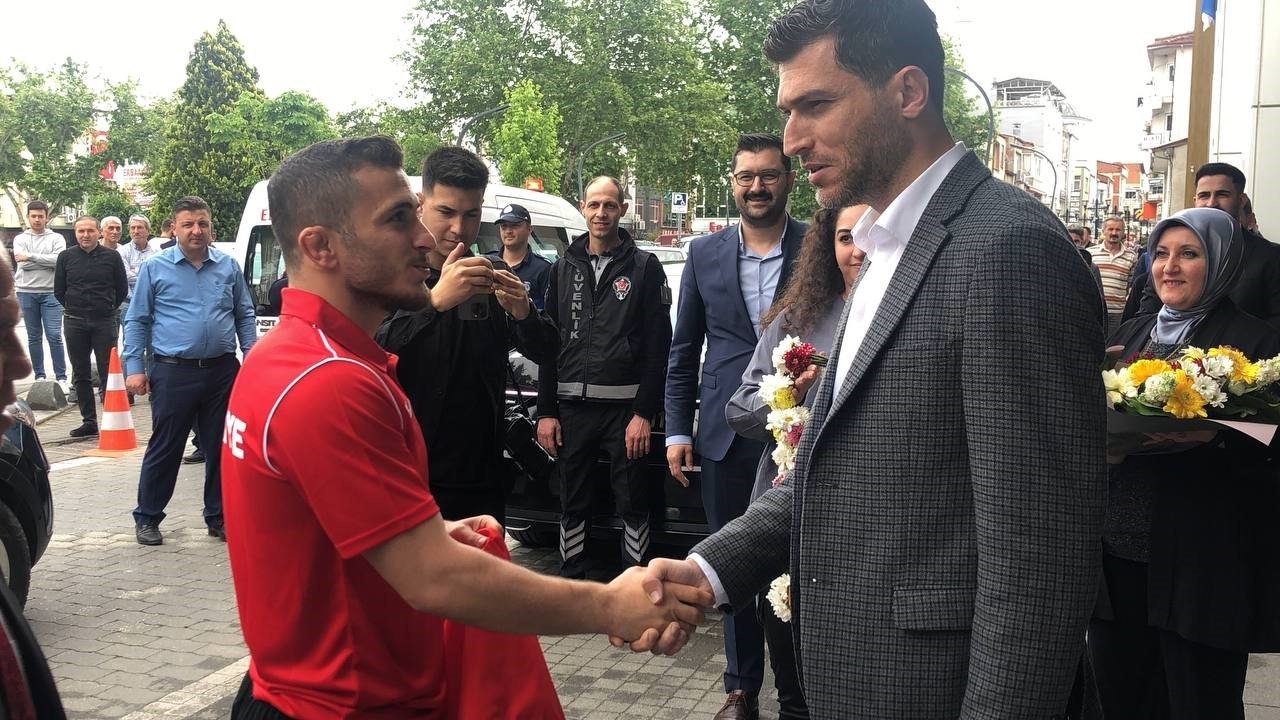 Dünya birincisi sporcu çiçeklerle karşılandı